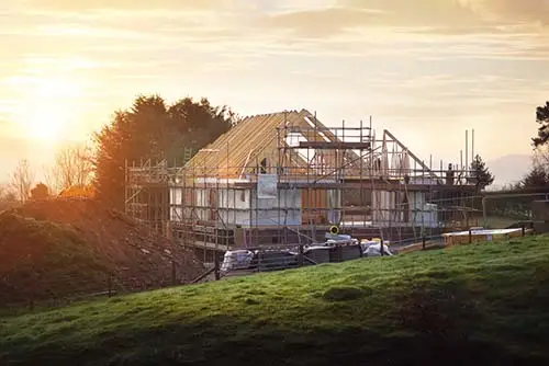 Building site with house under construction